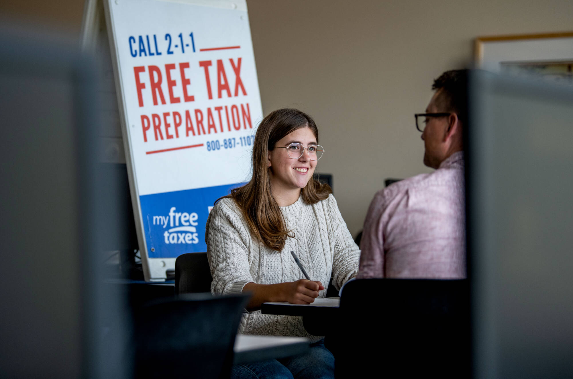 Volunteer Income Tax Assistance (VITA) shown with two people doing taxes
